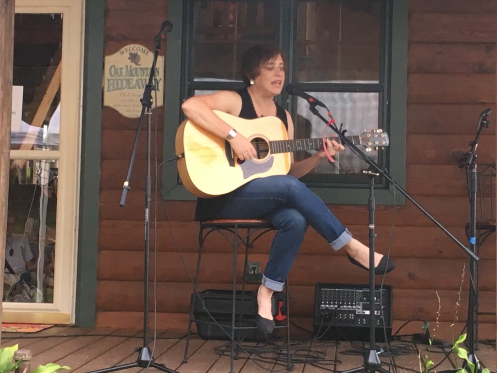 Michelle Katz singing and playing guitar